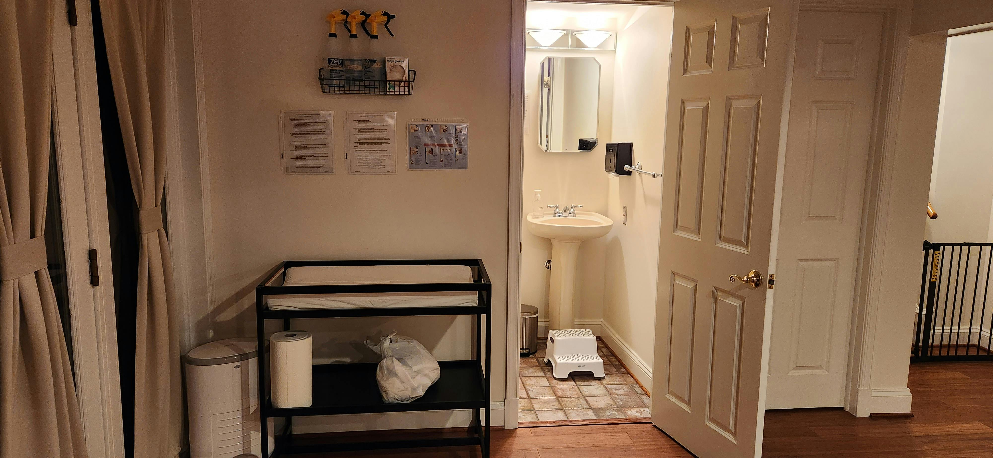 Changing table next to an open bathroom door