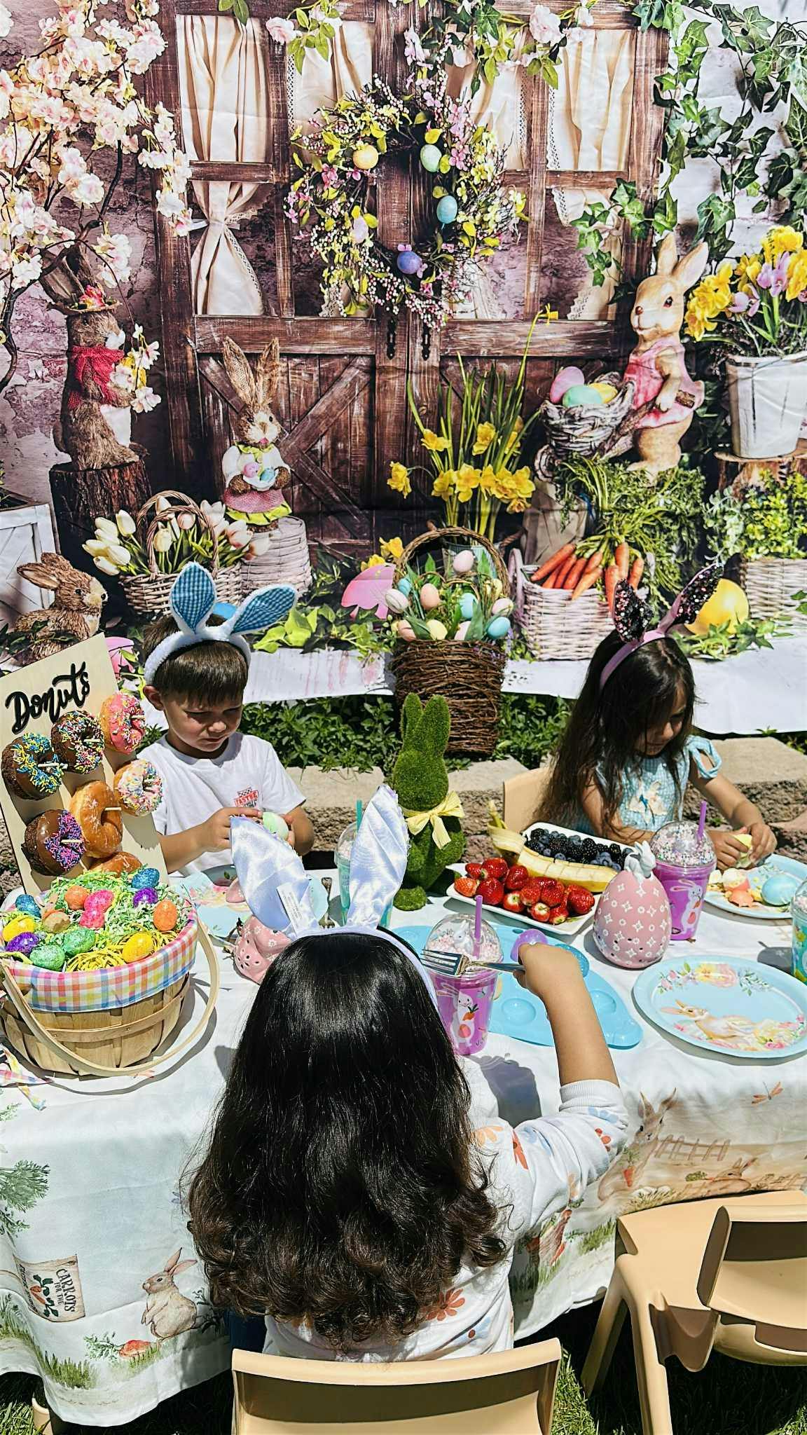 Children at a table with Easter decorations and food