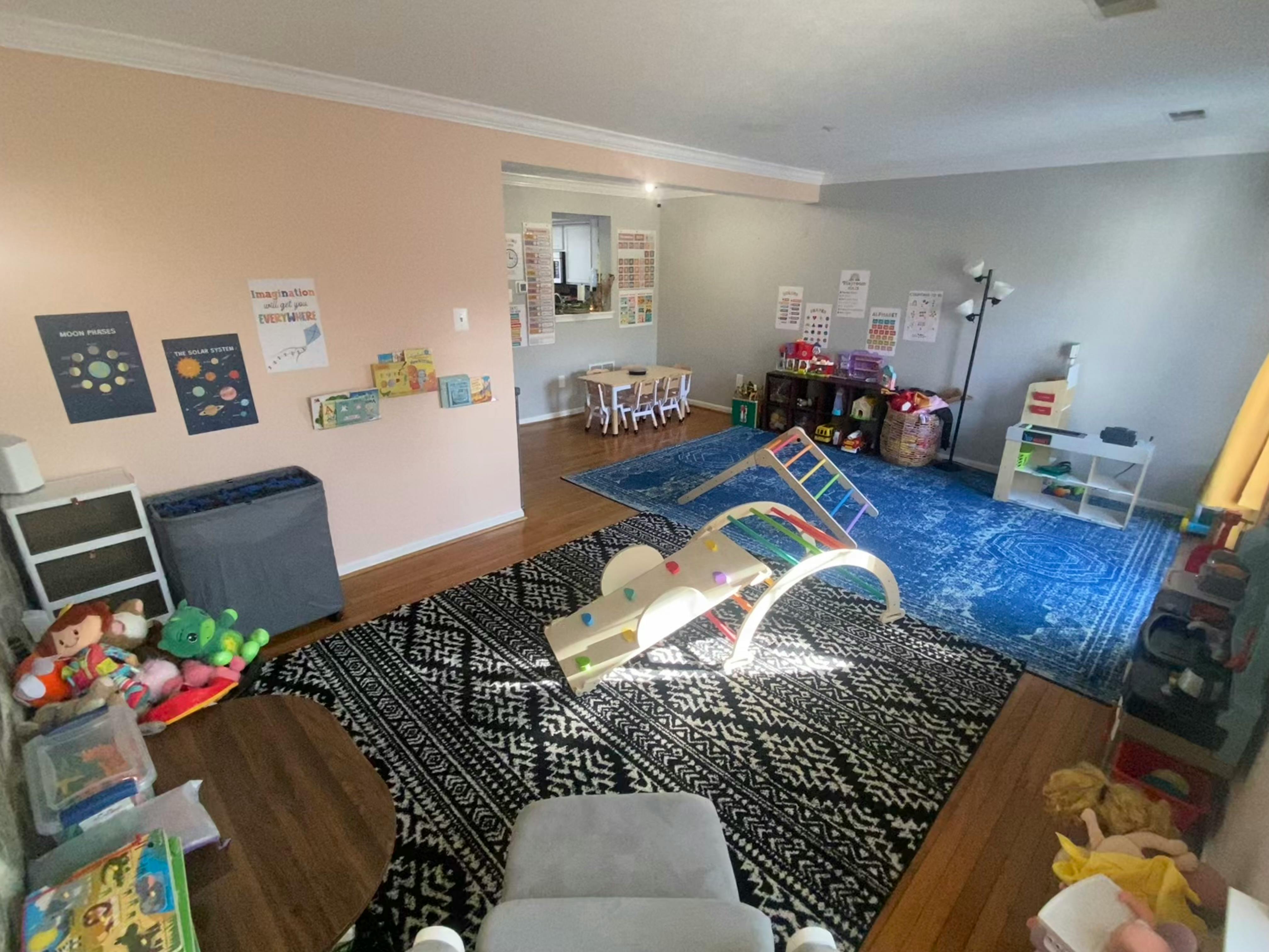 Playroom with climbing structures, rugs, and toys