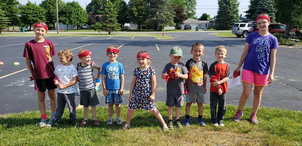 Group of children and teens standing outdoors