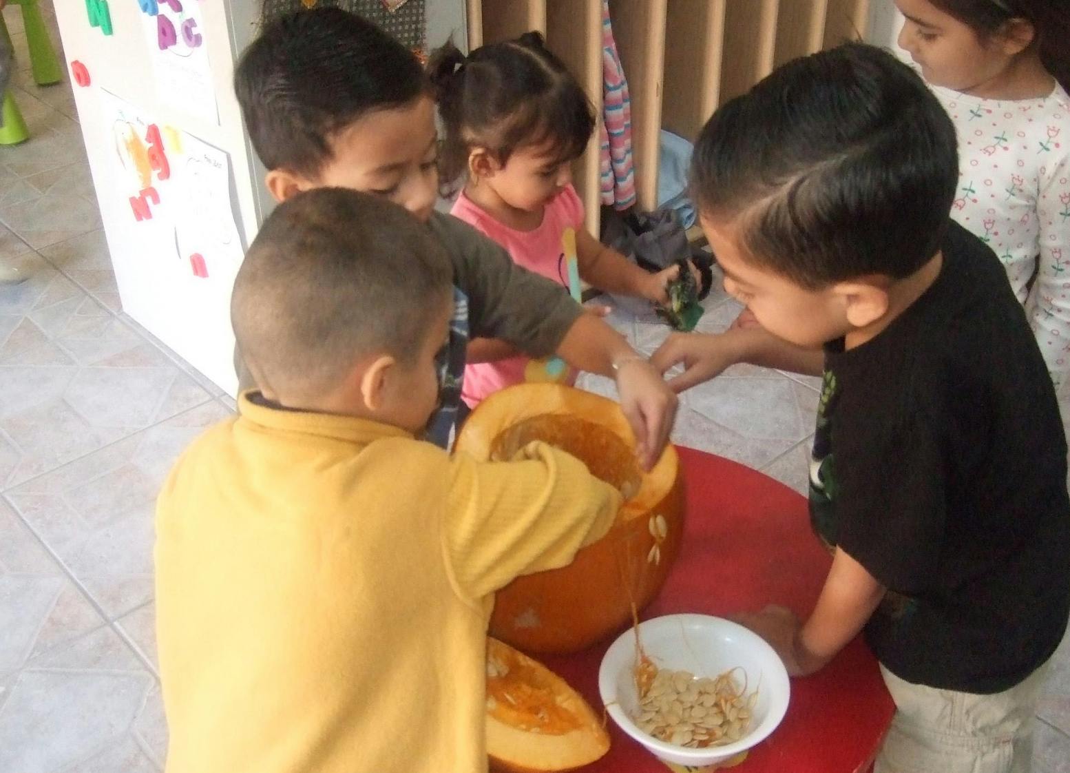 Children carving a pumpkin
