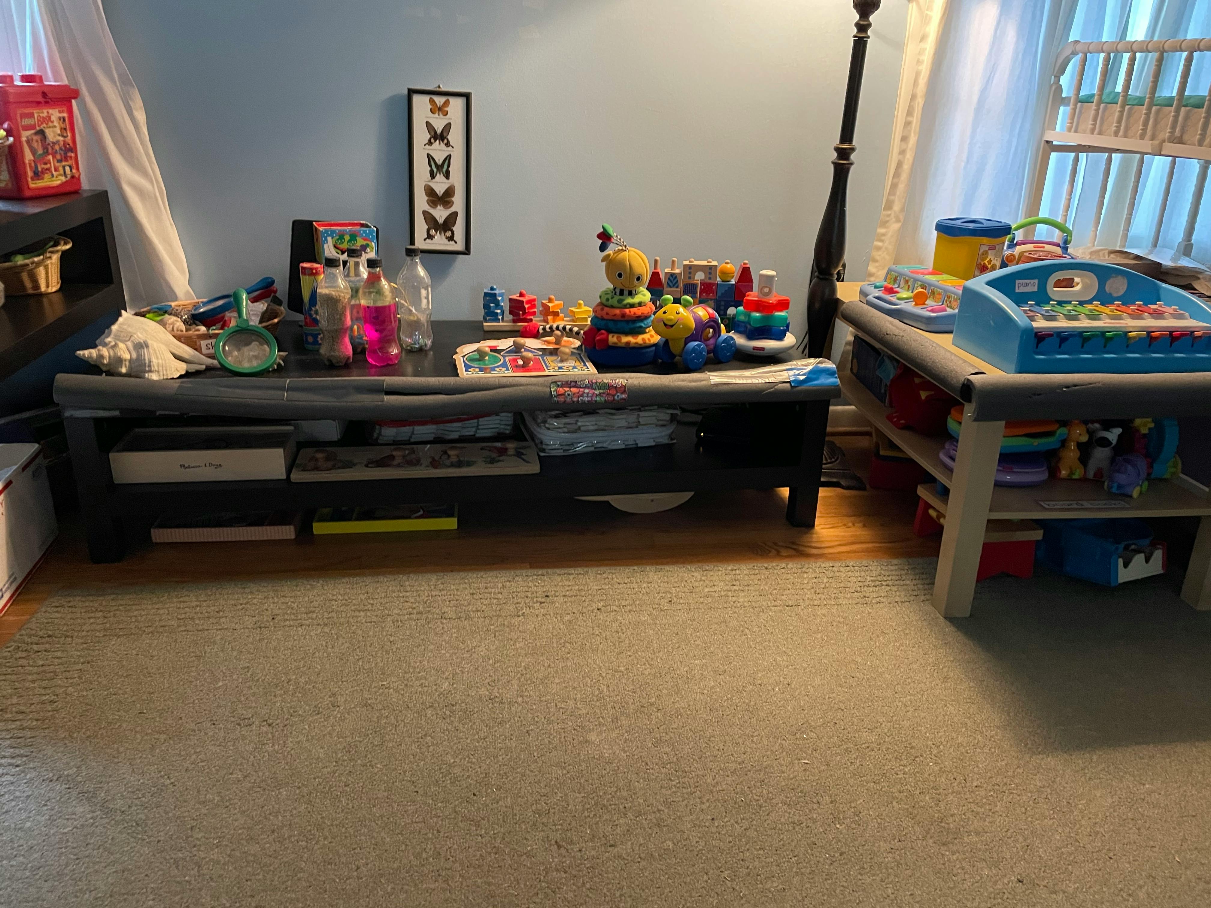 Two tables covered with various toys and objects
