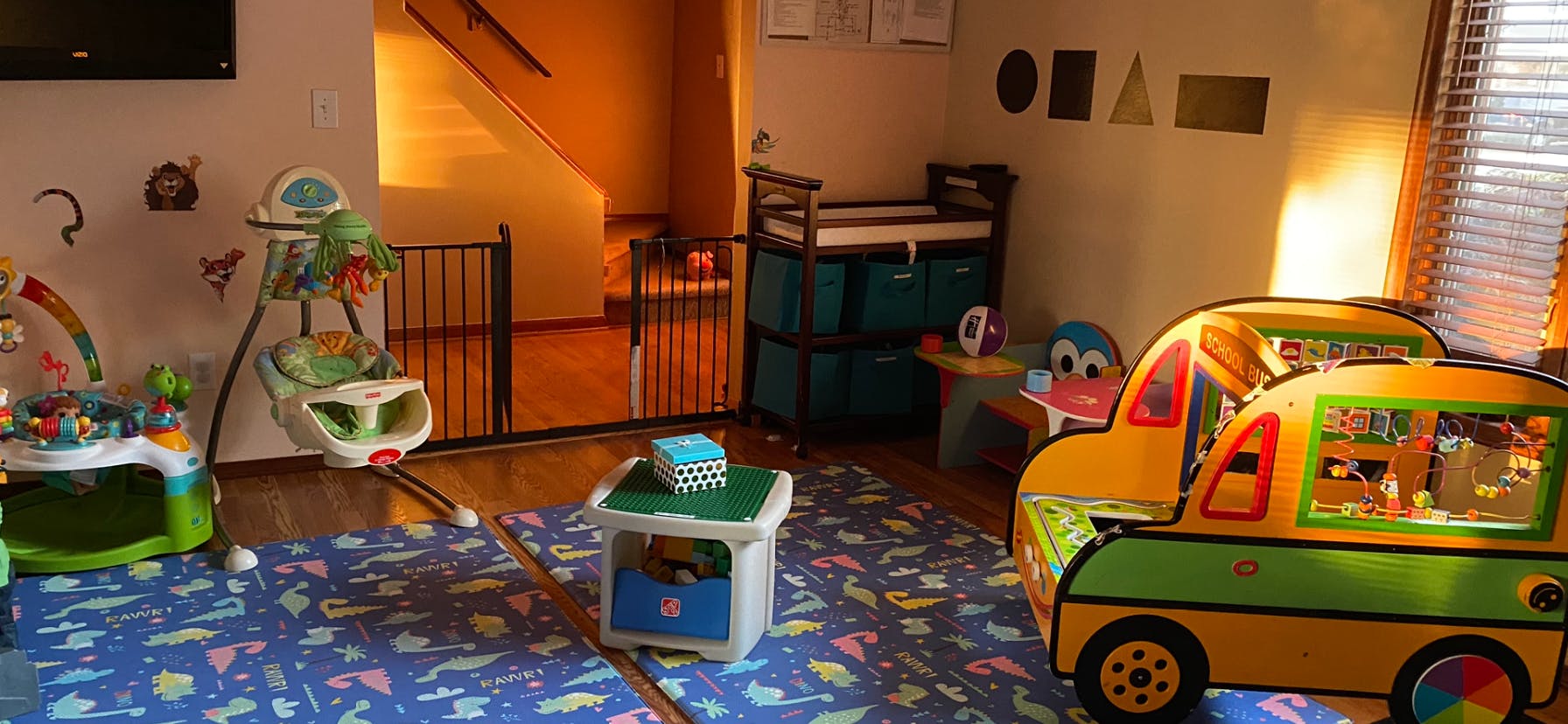 Playroom with baby bouncer, play mat, and toy car