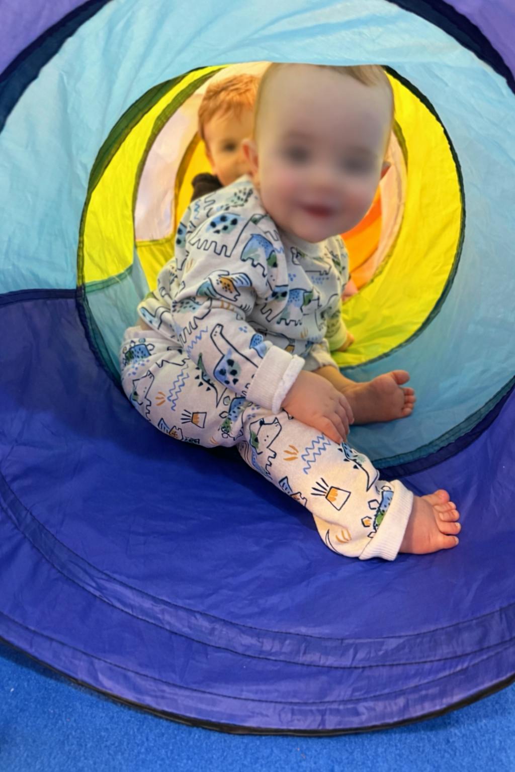Child in a play tunnel