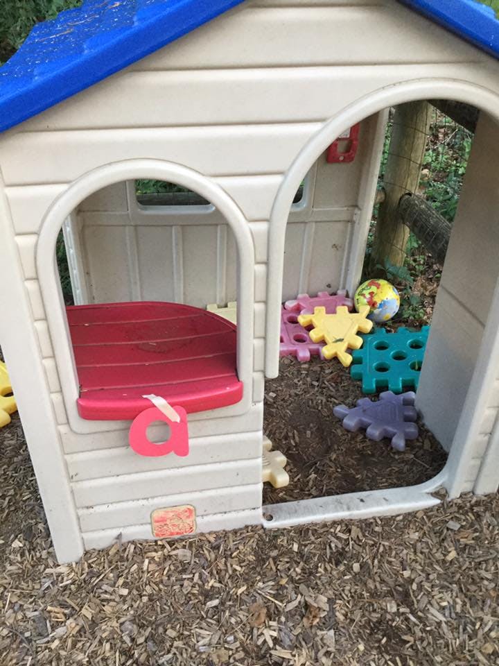 Playhouse with a red seat and colorful interlocking floor mats
