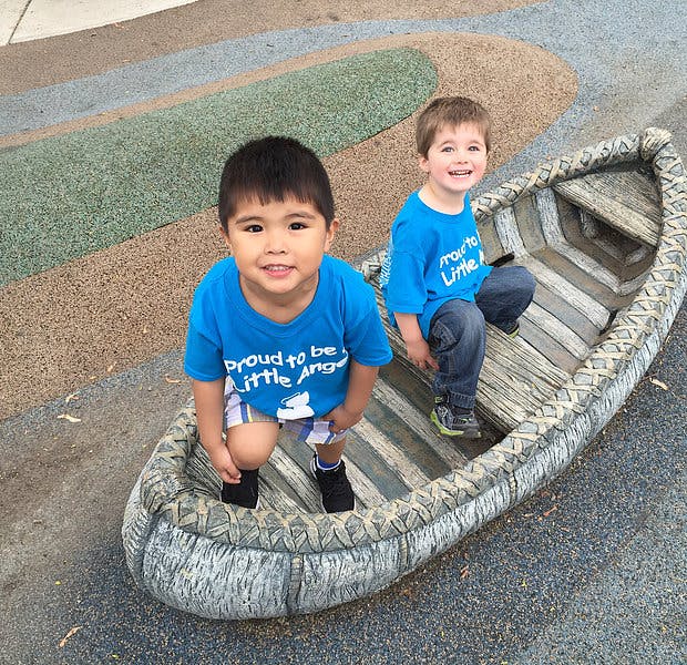 Two children in a small boat on a playground