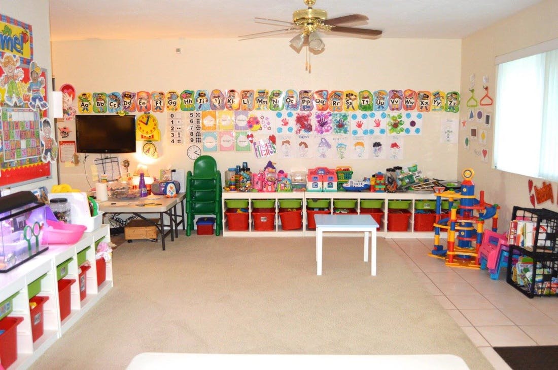Playroom with toys, storage, and children's artwork on the walls