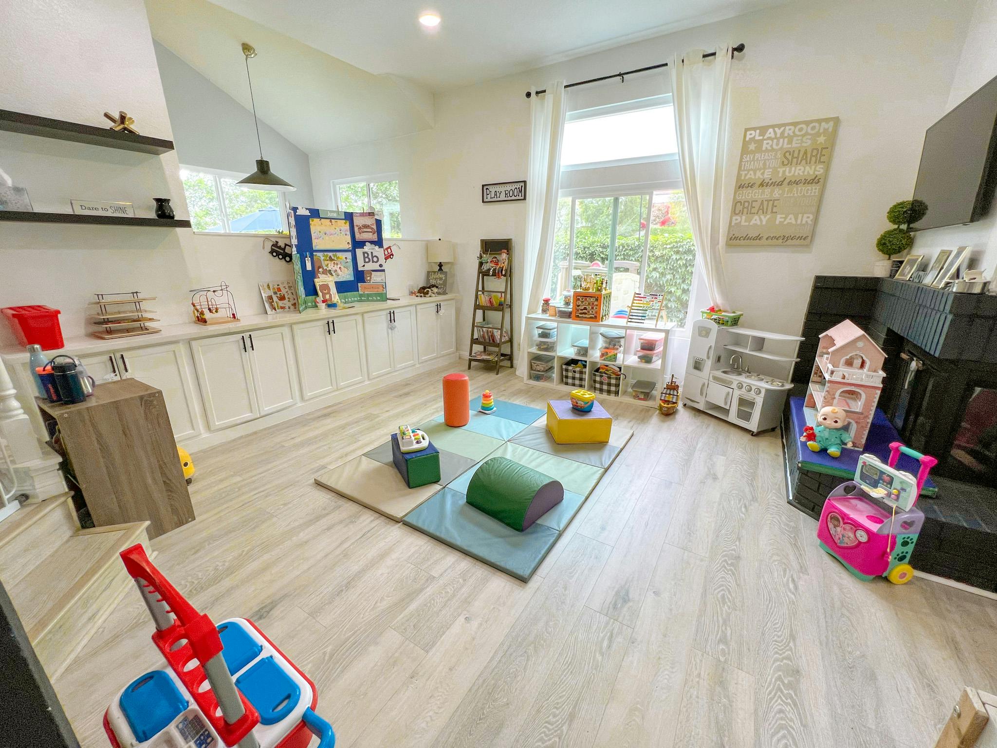 Playroom with a rug, toys, and shelves