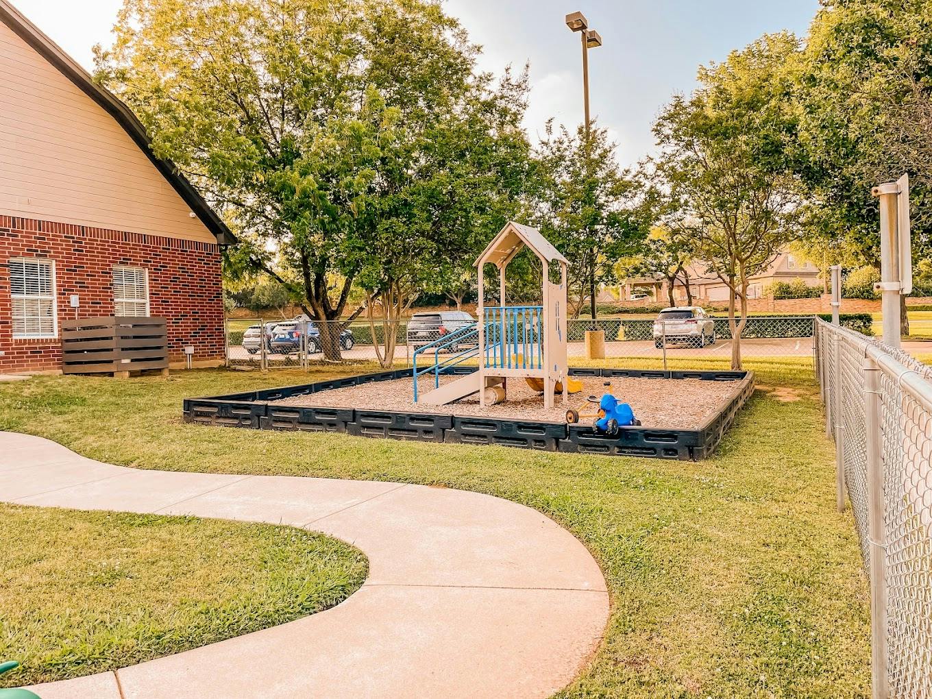 Small playground with a slide in a grass yard