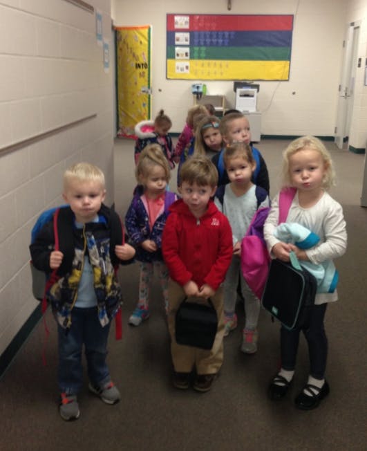 Group of children standing in a hallway