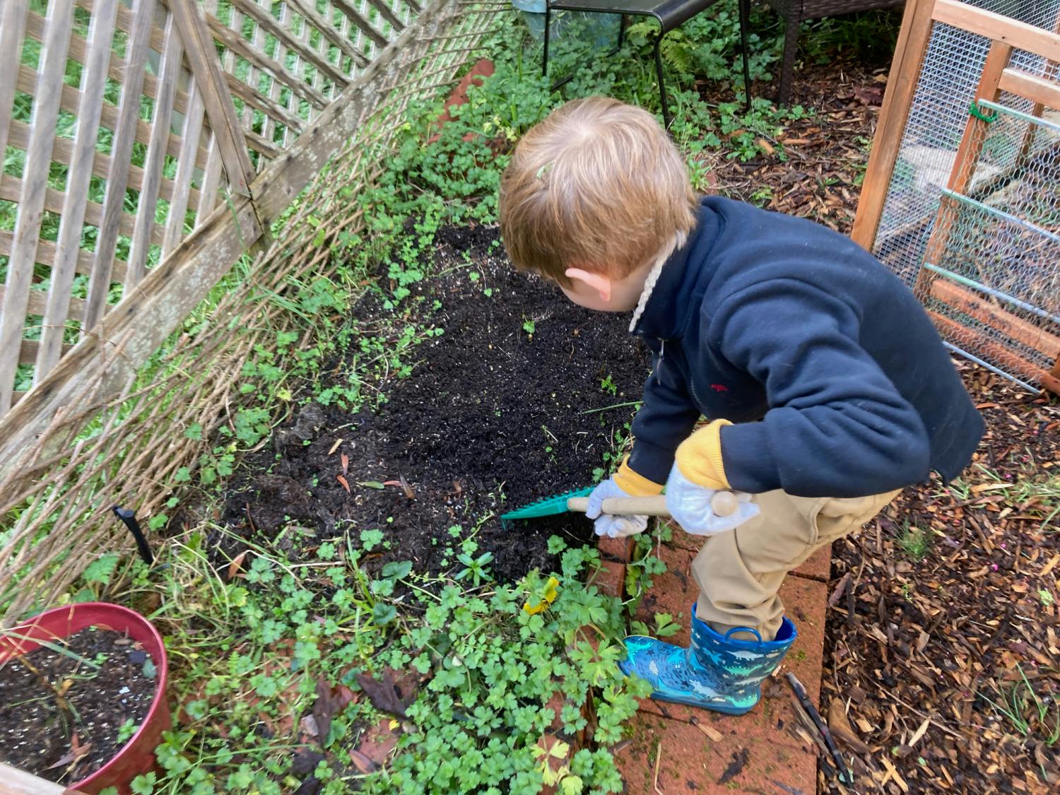 Child digging in garden with a trowel