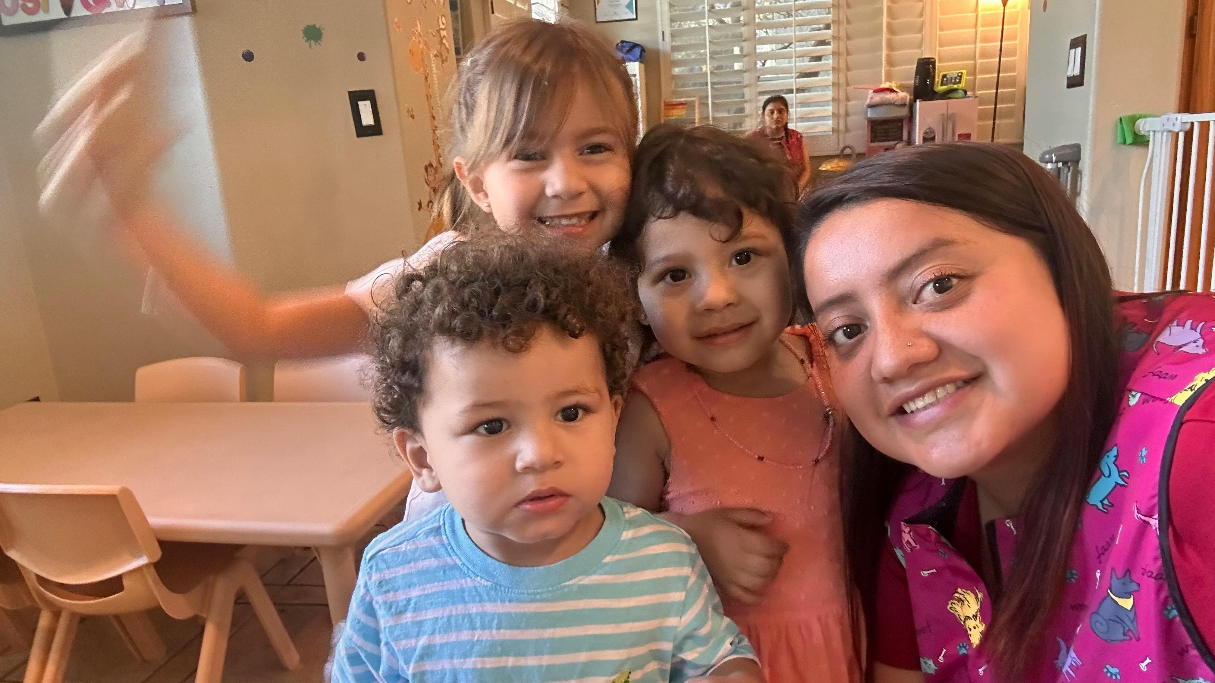 Adult and three children posing for a photo