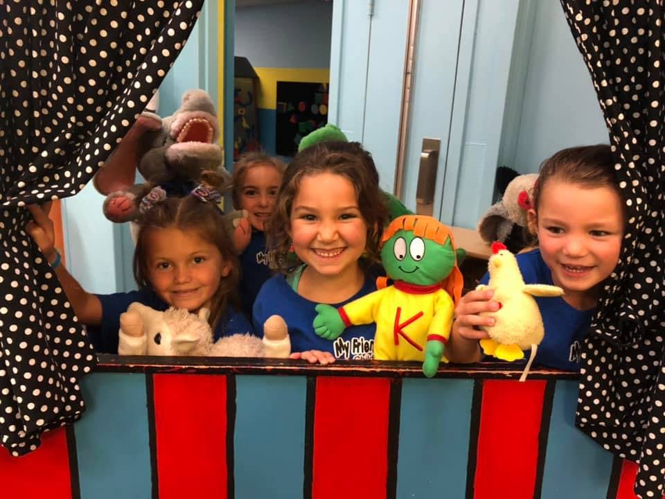 Children with puppets in a puppet theater