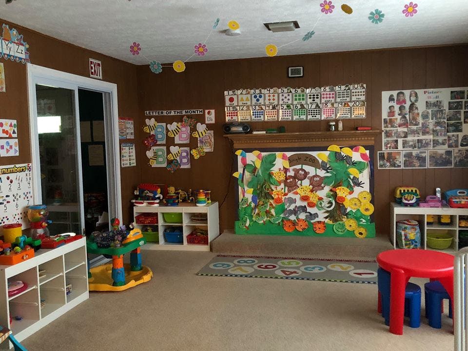 Playroom with toys, shelves, and colorful decorations on the walls and ceiling