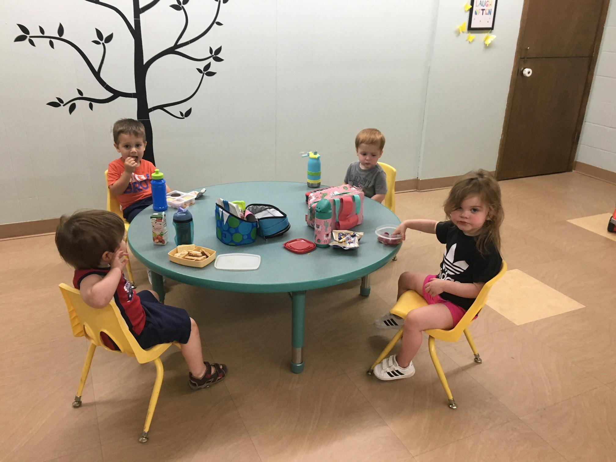 Four children sitting around a small round table