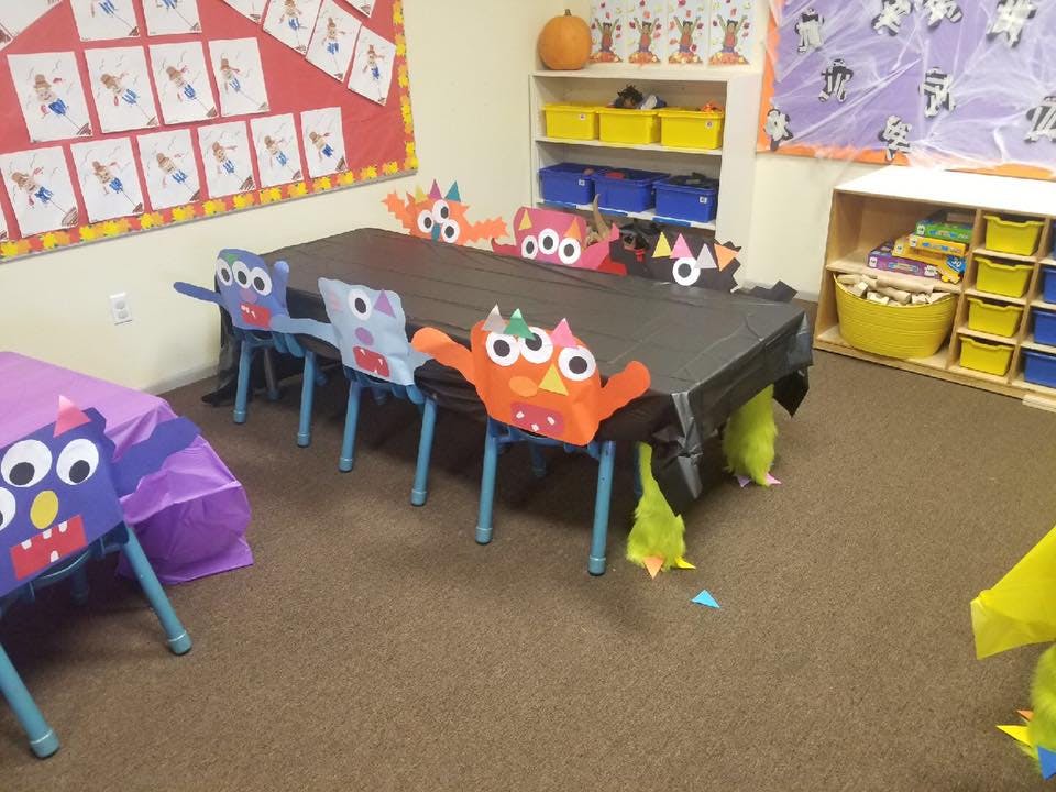 Classroom with tables and chairs decorated with monster cutouts