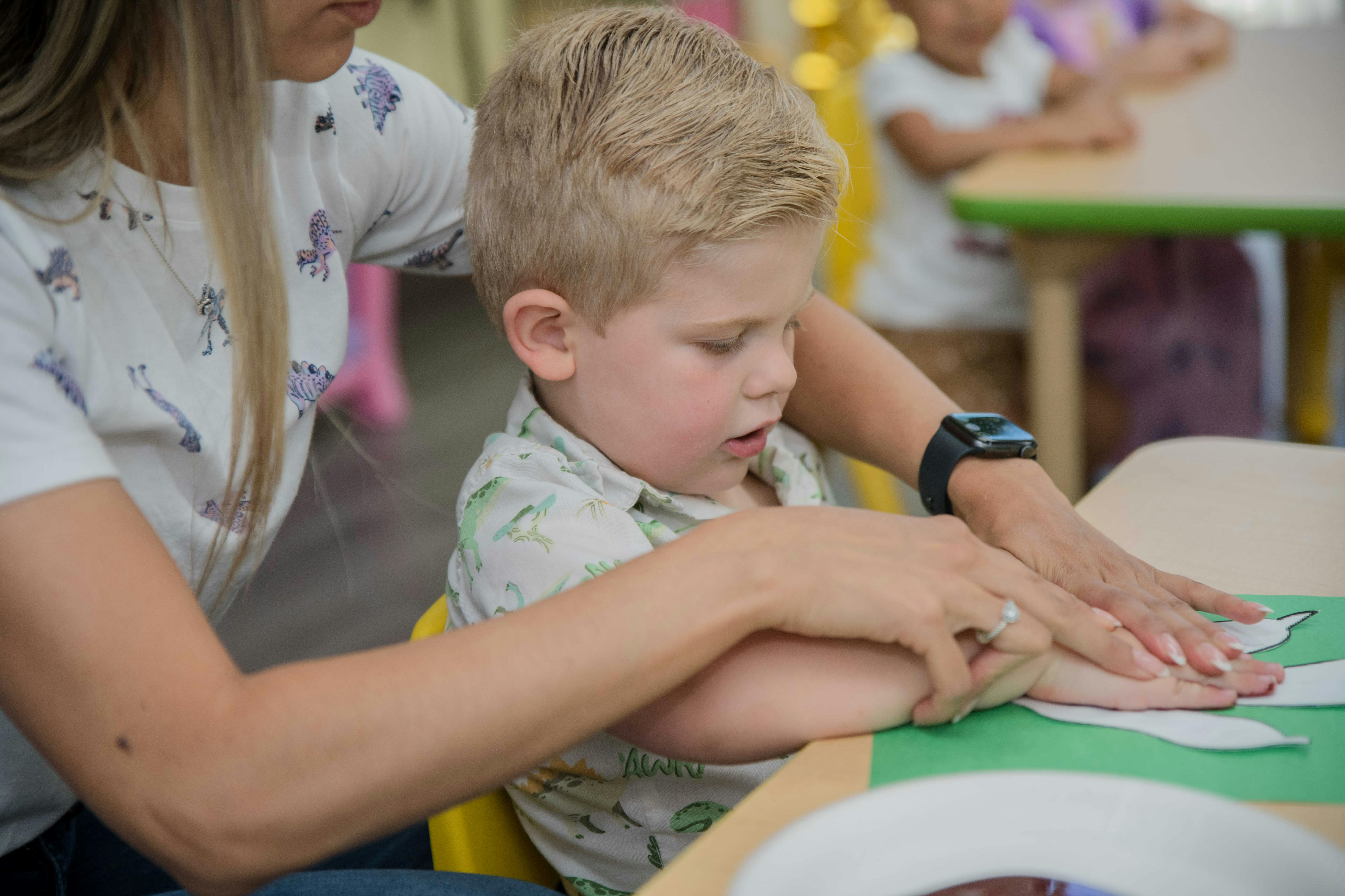 Adult and child doing an art activity at a table