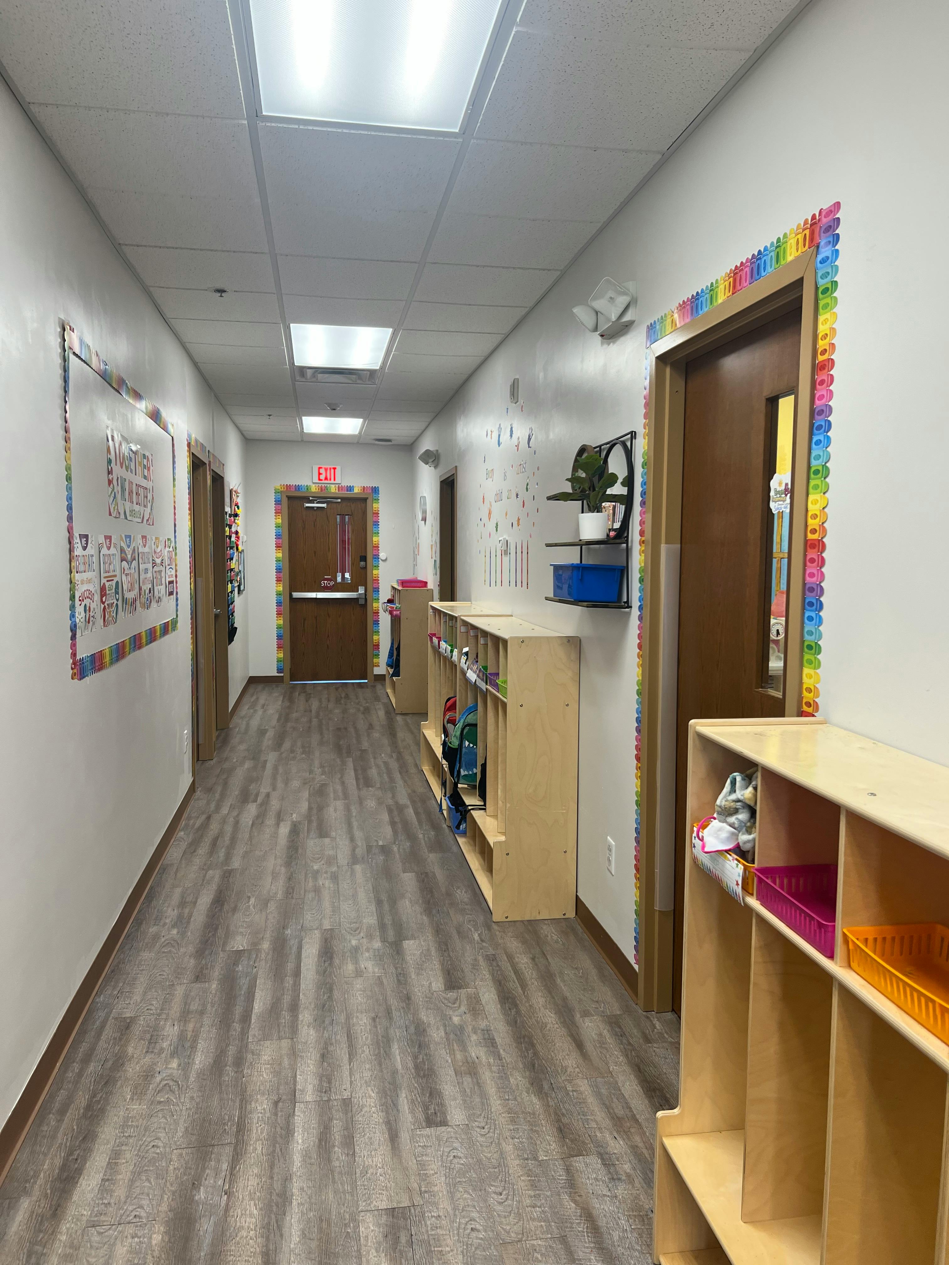 Hallway with wooden floors and cubbies along the walls