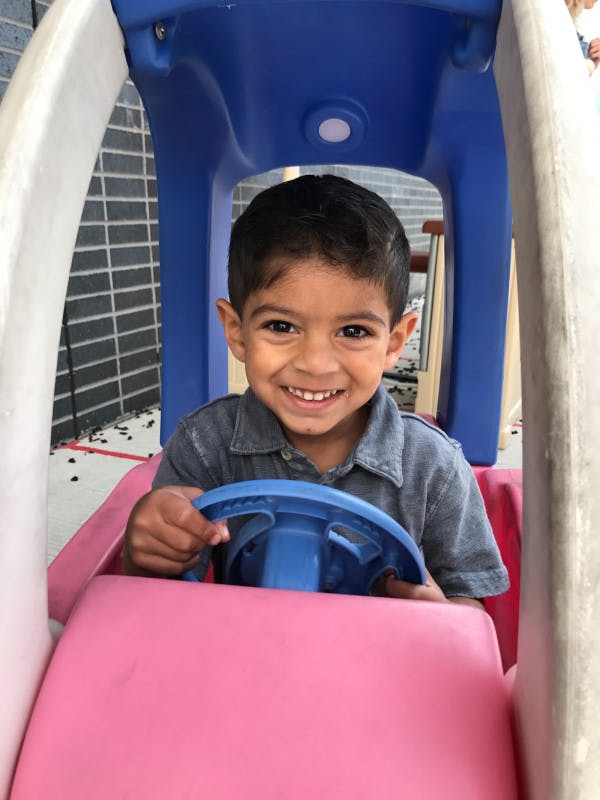 Child in a toy car