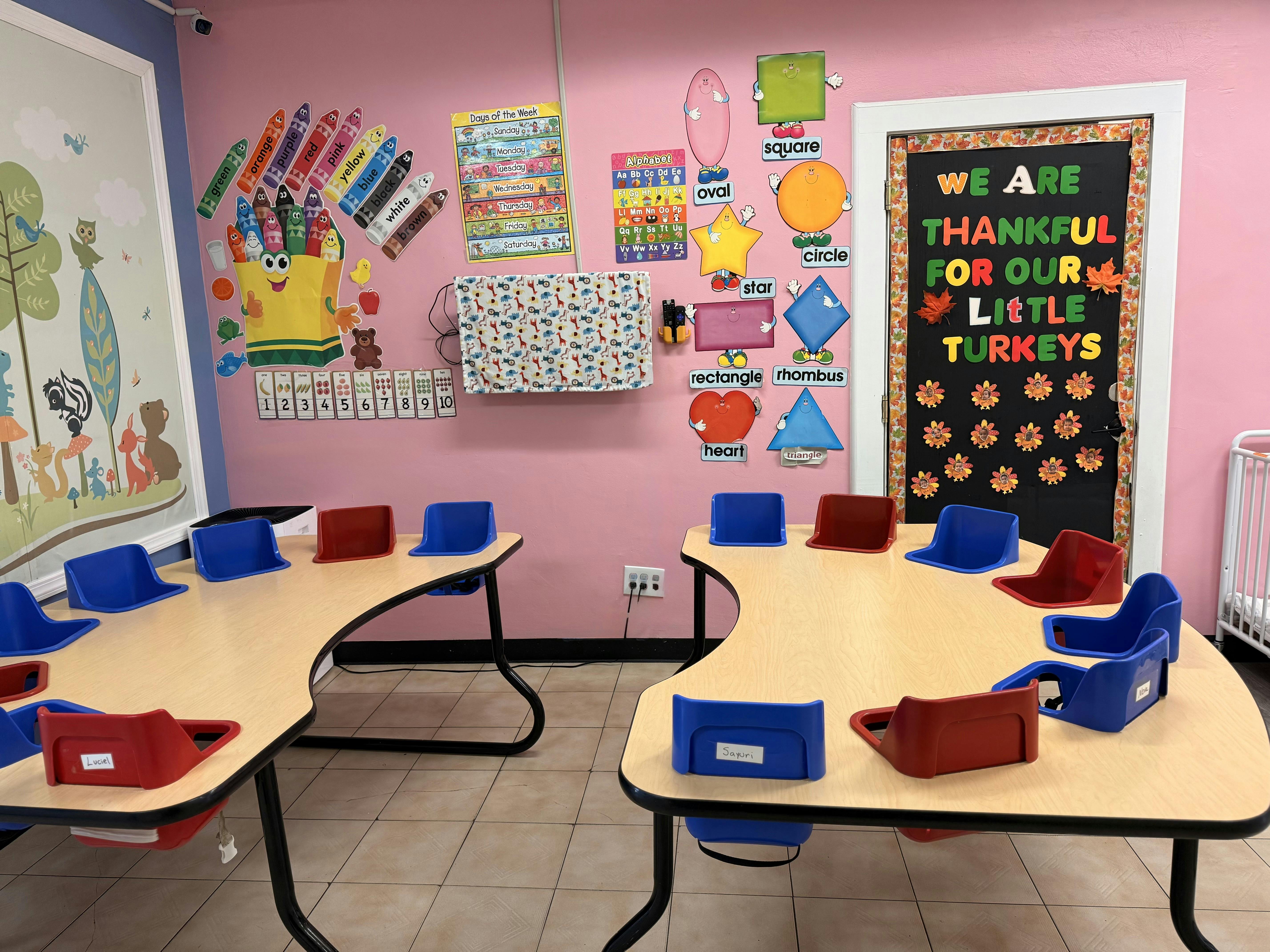 Classroom with small tables and chairs, decorated walls