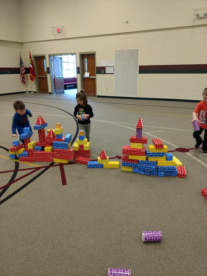 Children playing with large building blocks in a gym