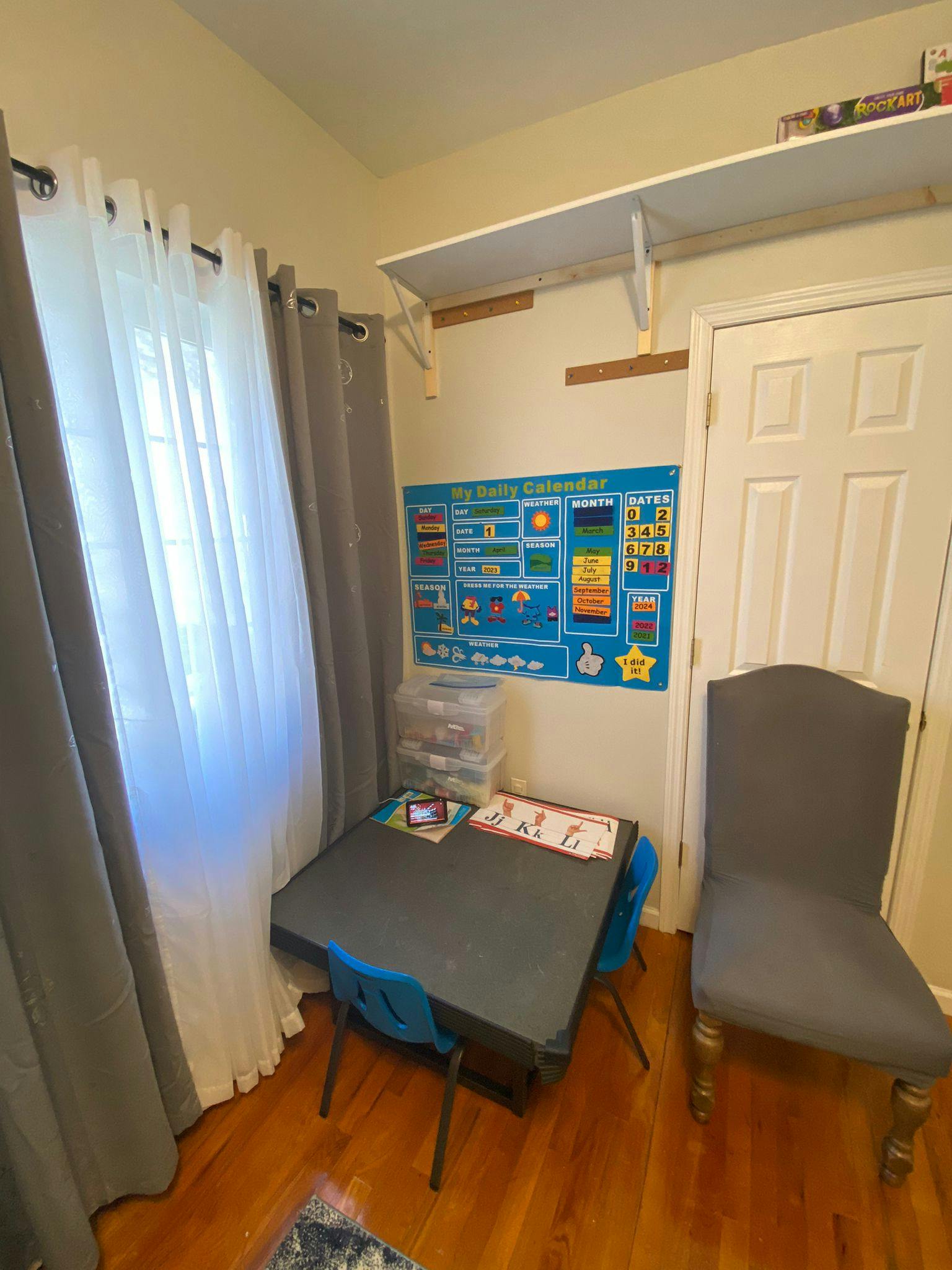 Child's table and chairs with a calendar chart on the wall