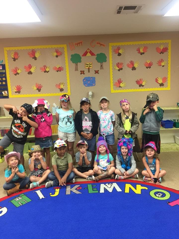 Group of children posing in a classroom