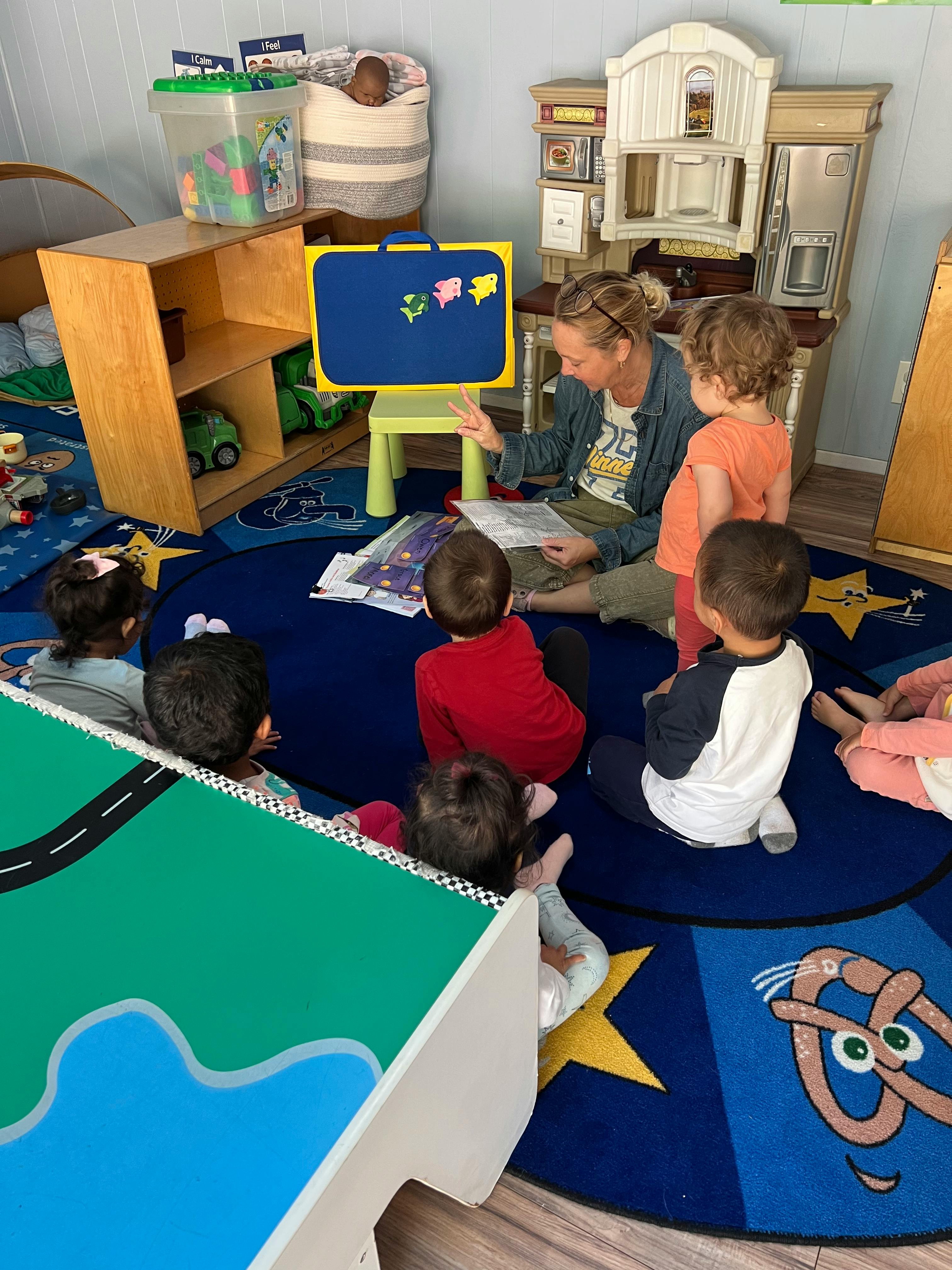 Adult reading to children in a classroom