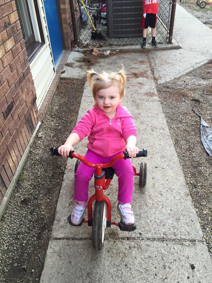 Child on a red tricycle