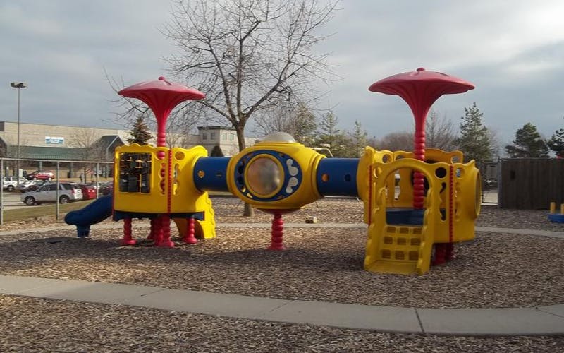 Yellow and blue playground equipment with red accents