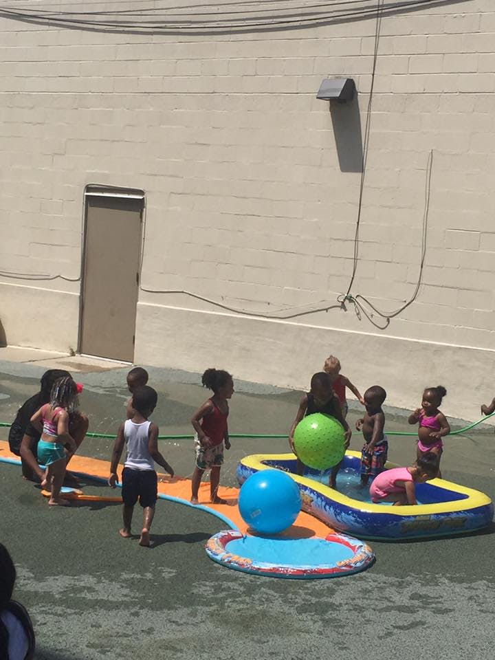 Children playing in inflatable pools with large balls