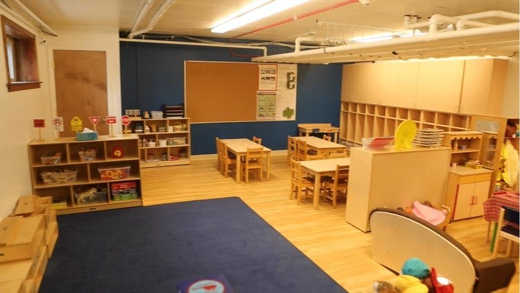 Empty classroom with small tables and chairs