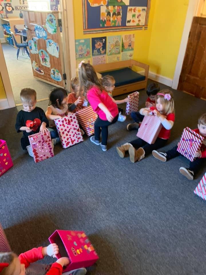Children opening gifts in a classroom