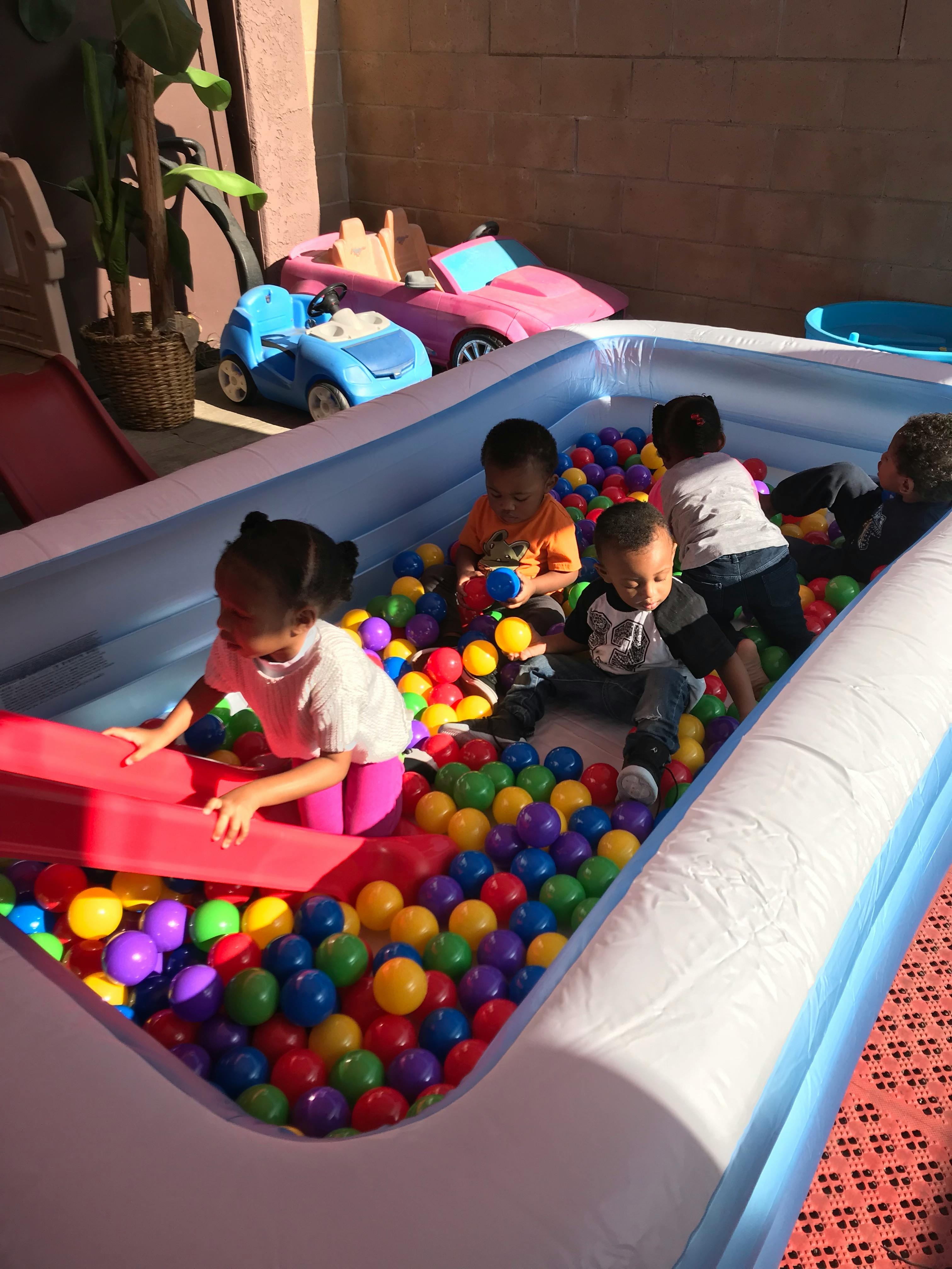 Children playing in an inflatable ball pit