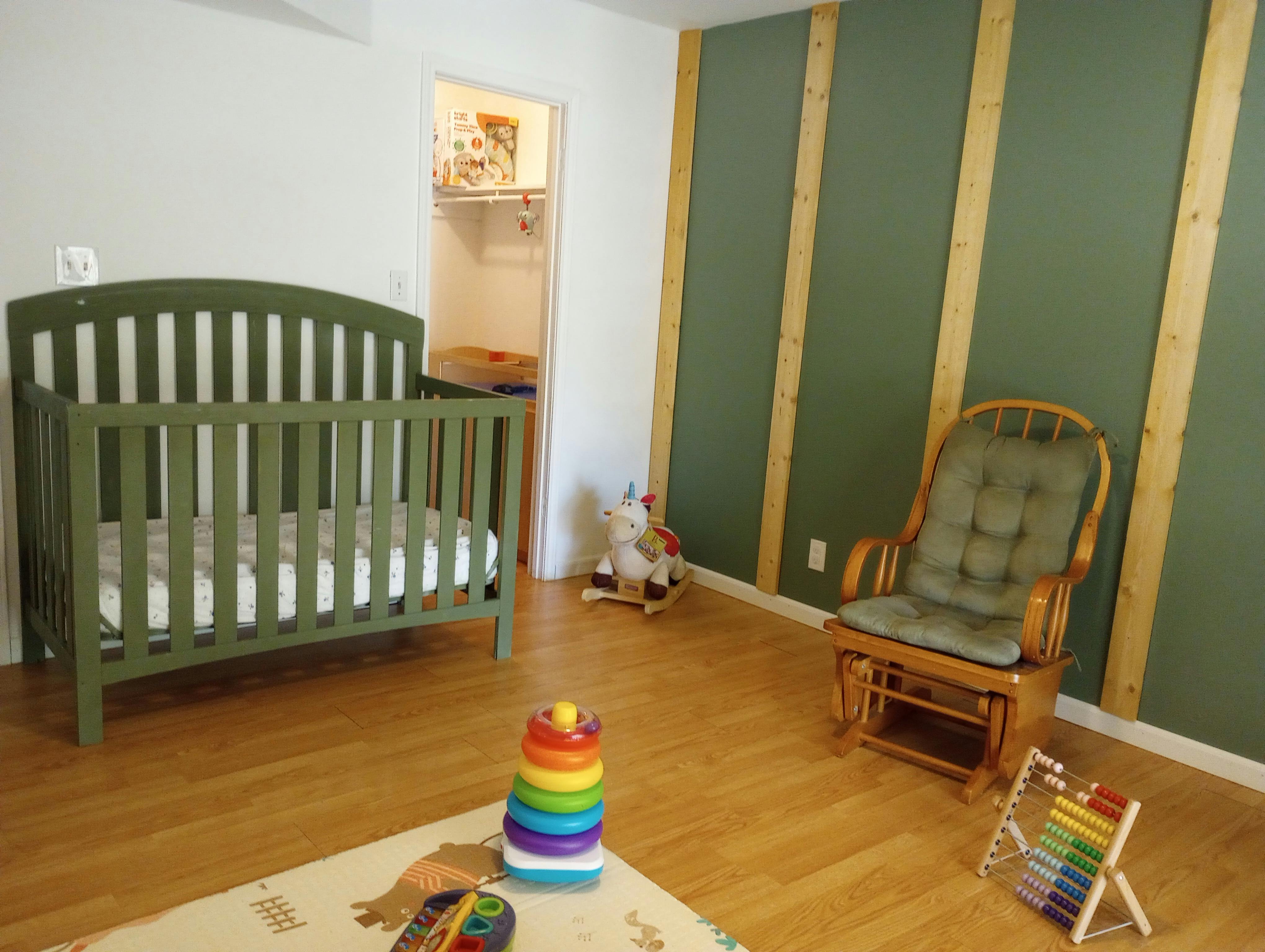 Crib, rocking chair, and toys in a room
