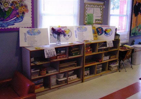 Shelves with learning materials and posters in a classroom