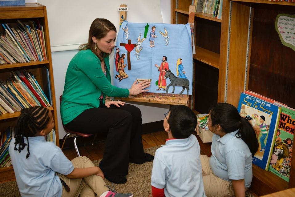Person teaching children with a visual aid