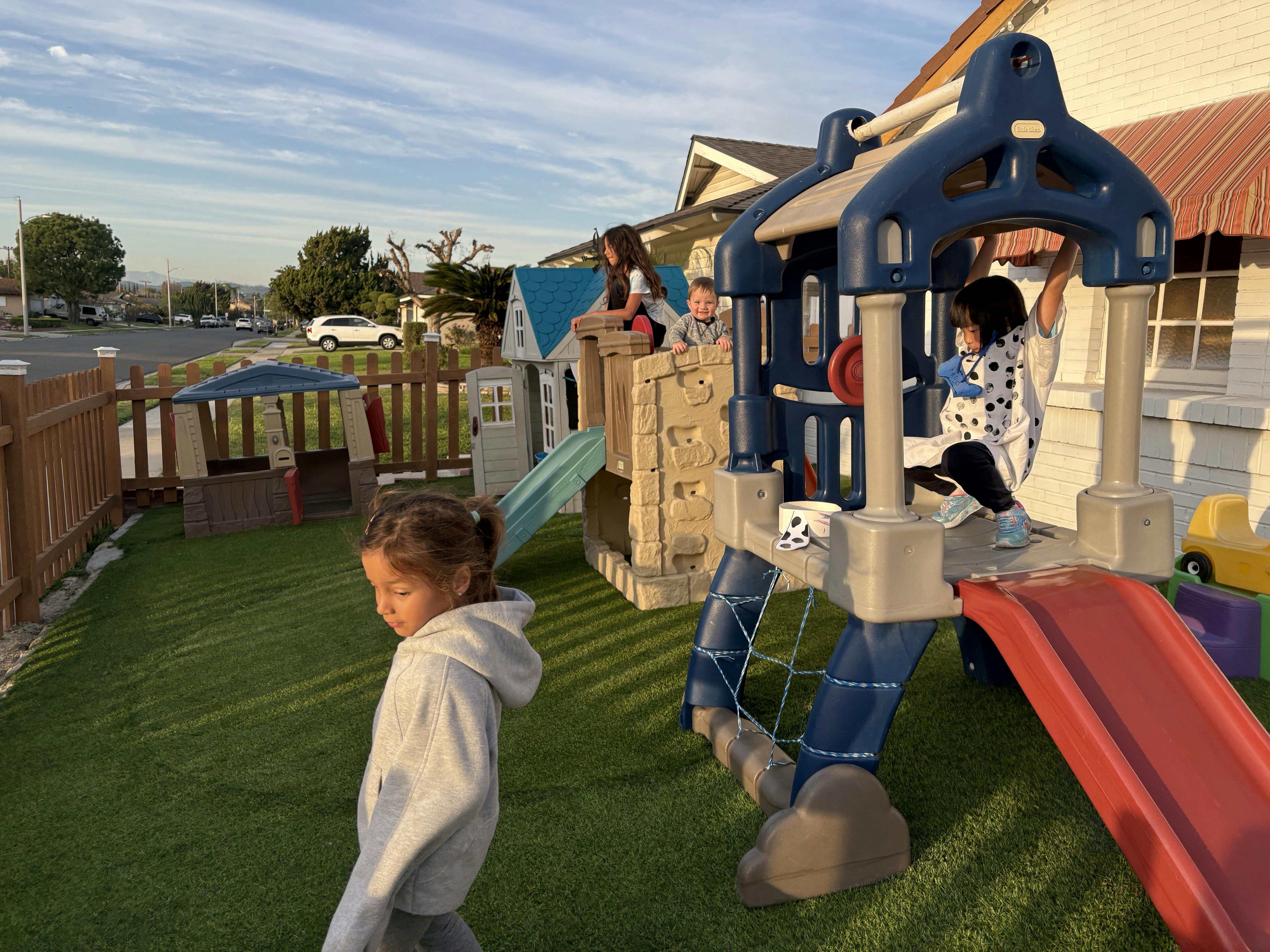 Children playing on a backyard playset