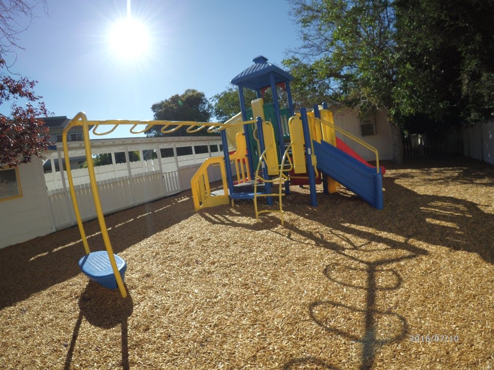 Playground with monkey bars, slide, and climbing structure