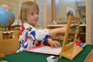 Child using an abacus at a table