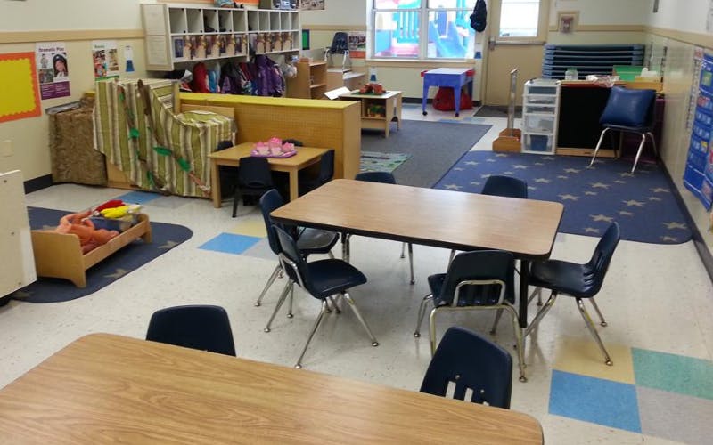 Empty classroom with small tables and chairs