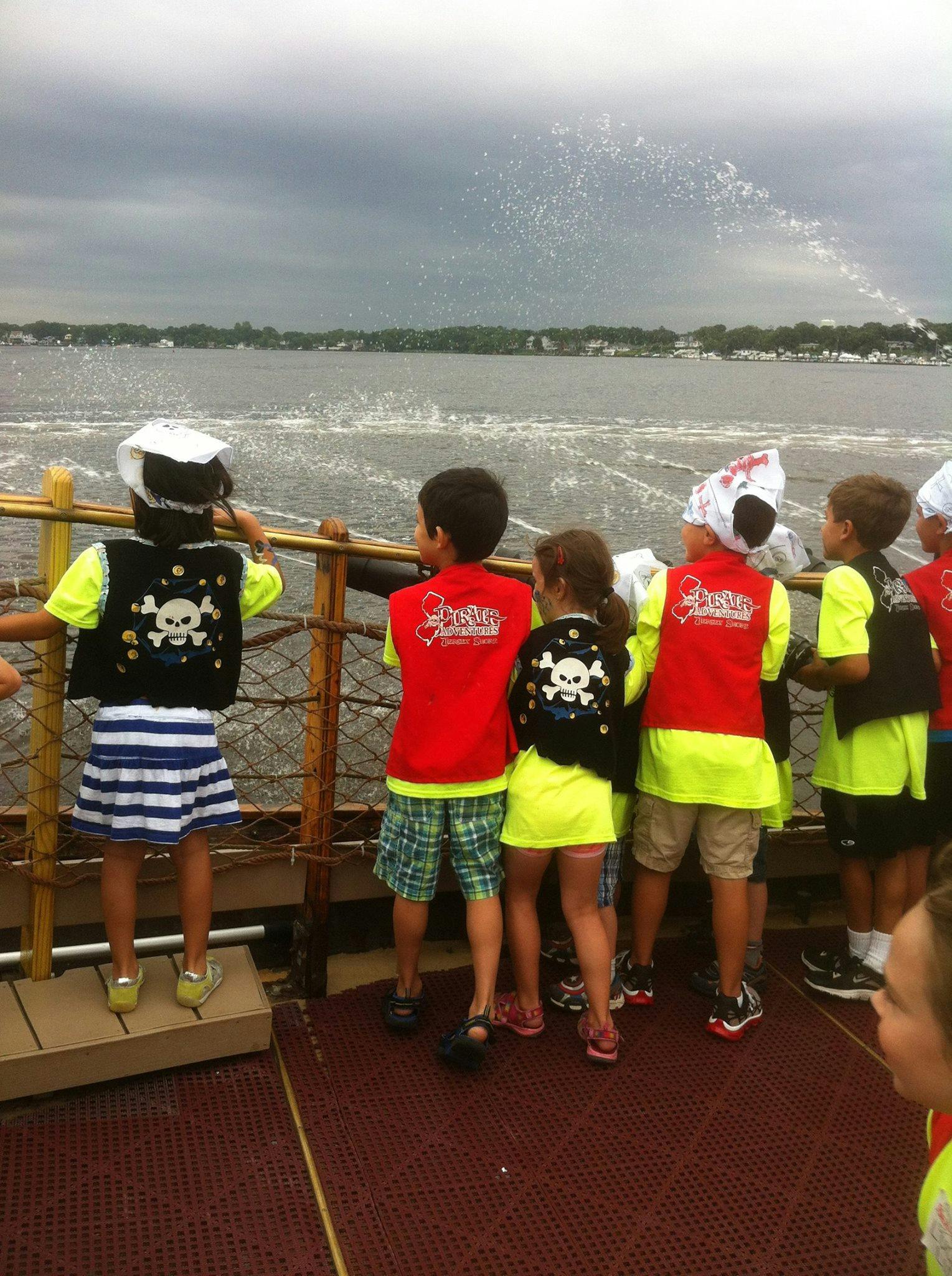 Children on a boat looking out at the water