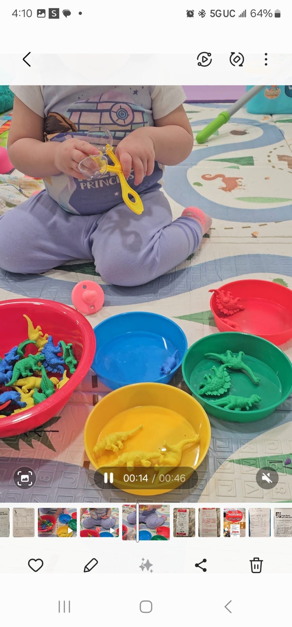 Child playing with colorful bowls and dinosaur toys
