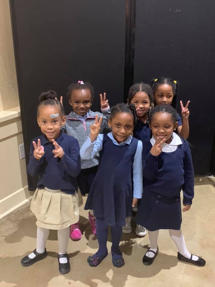 Group of children making peace signs