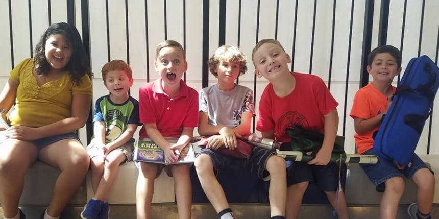 Six children sitting in a row