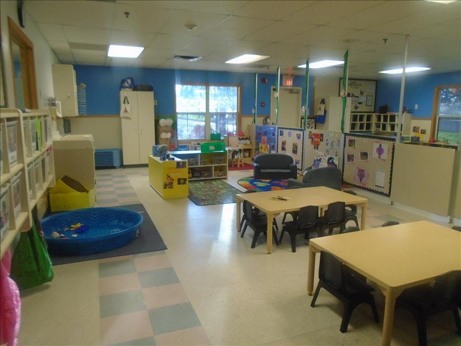 Empty colorful classroom with small tables and chairs