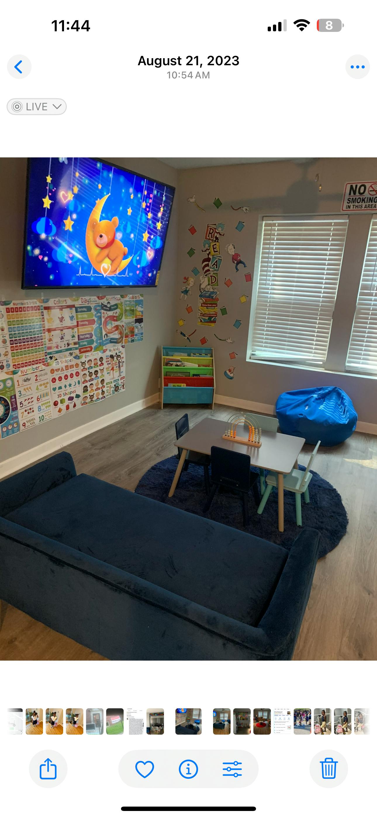 Children's play area with a TV, sofa, small table and chairs, and beanbag