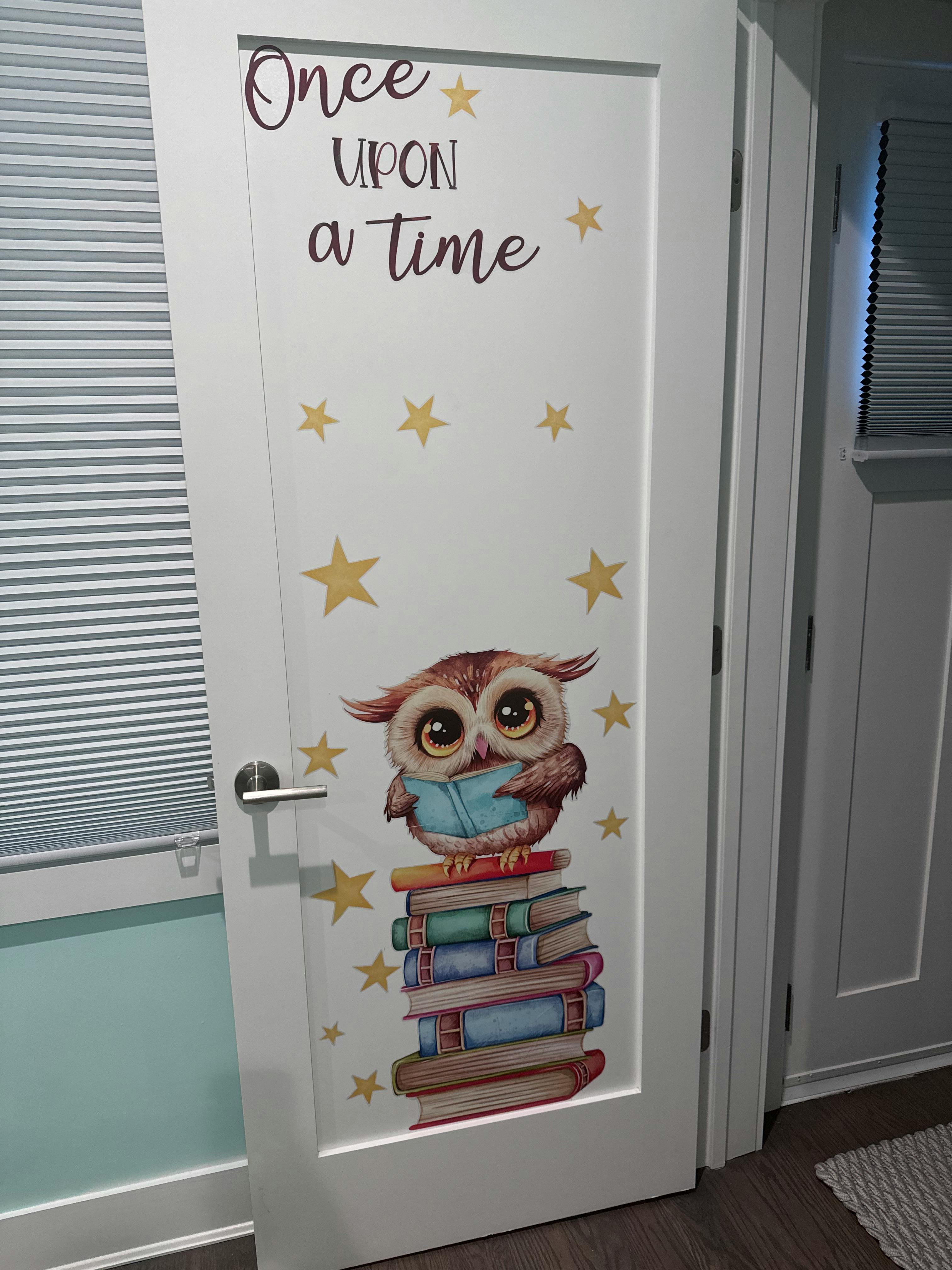 White door with "Once upon a time" text, stars, and an owl on books