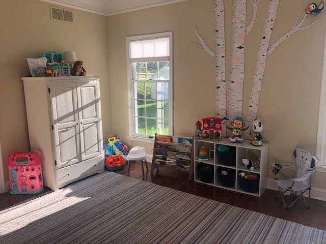 Child's room with a wardrobe, window, and toy storage