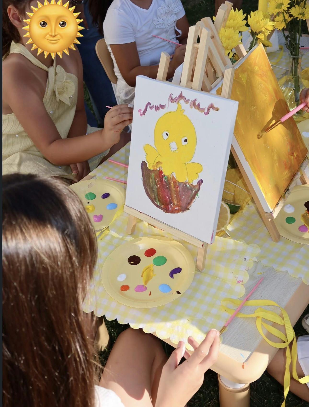 People painting chick illustrations on small canvases at a table